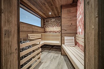 A wooden sauna with a window and wooden benches