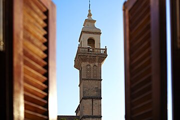 wooden shutters with ancient tower view