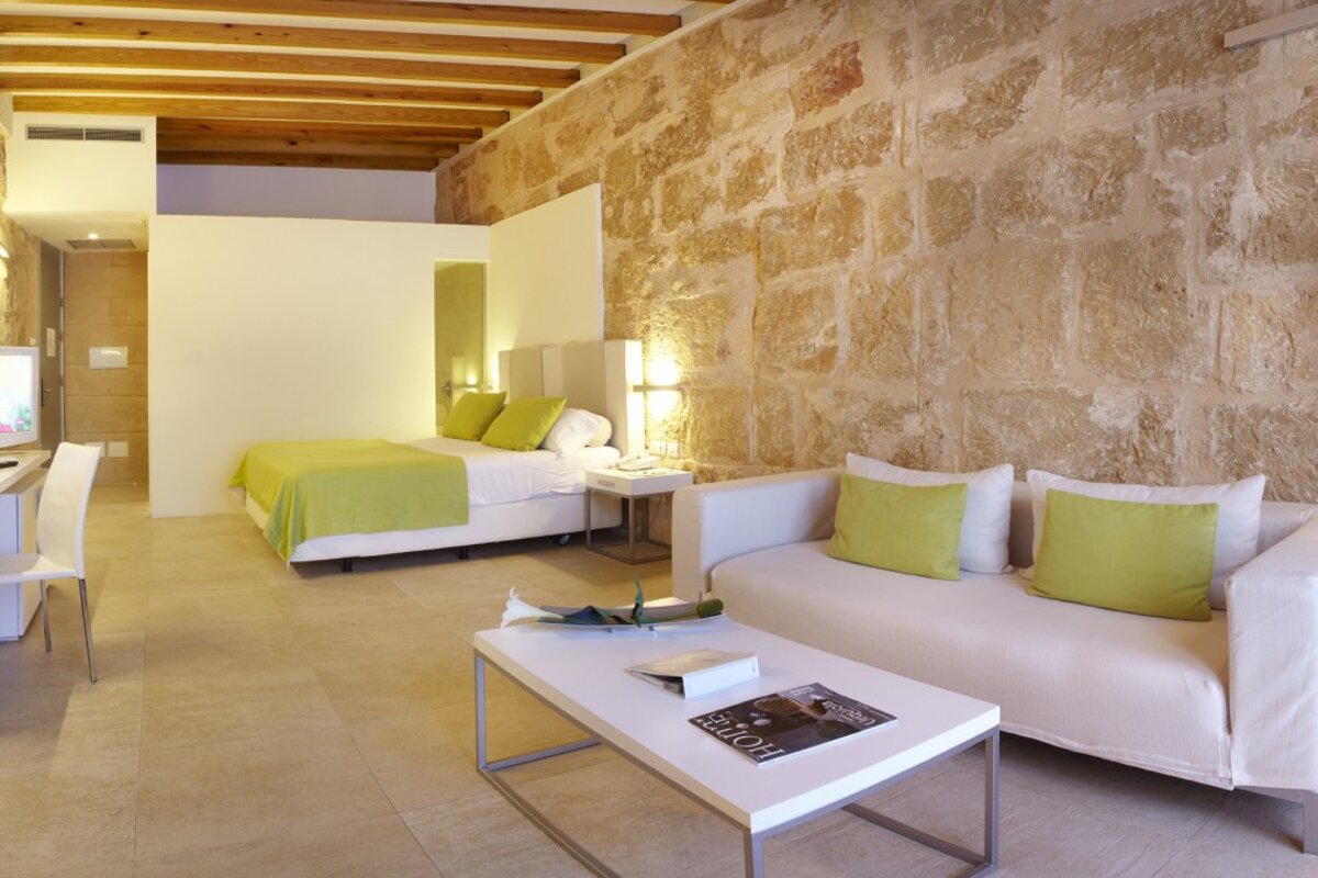 white & green decor in a stone bedroom suite