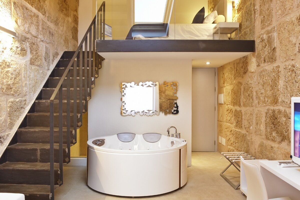 mezzanine bed with spa bath central to the room
