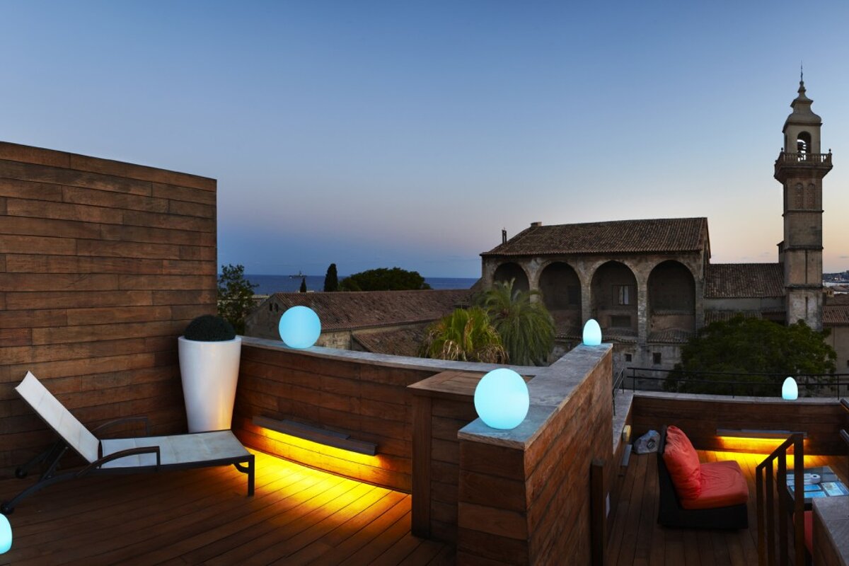 a roof top at sundown with pretty lights and great view