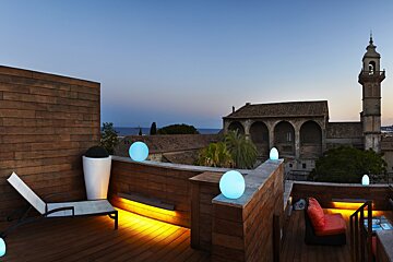 a roof top at sundown with pretty lights and great view