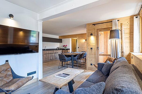 A living room with a couch and a flat screen tv