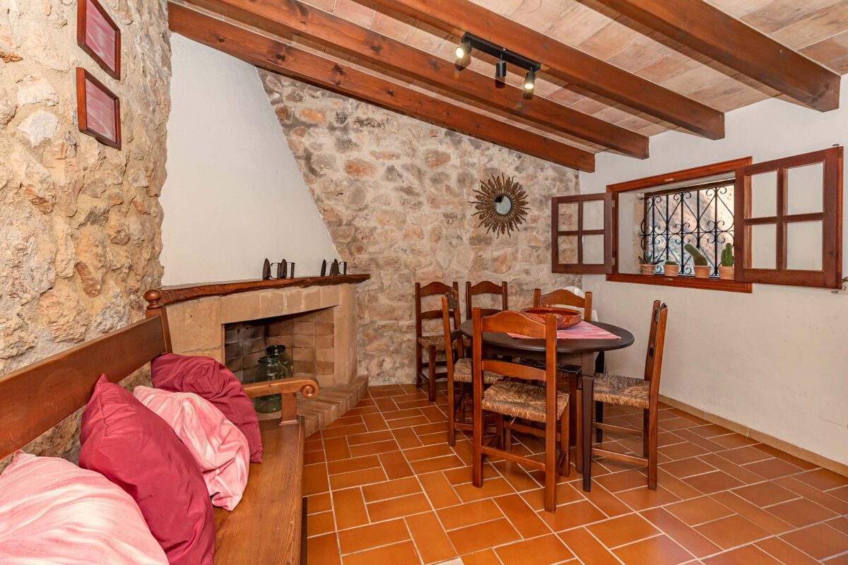 A dining room with a table and chairs and a fireplace