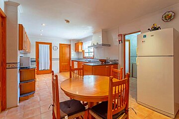 A kitchen with a table and chairs and an lg refrigerator