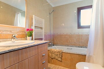 A bathroom with a sink a toilet and a bathtub