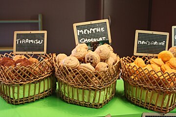 sweet macaroons in heart shaped baskets