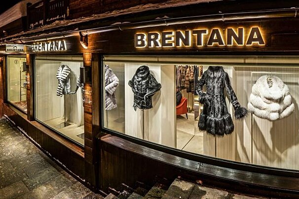 A store called brentana has many fur coats on display