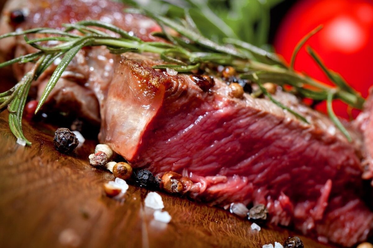 a chunk of steak cooked on a board