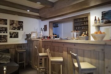 A wooden bar in a restaurant with a sign that says ' a ' on it