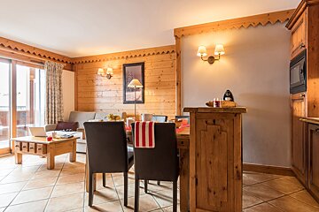A living room with a dining table and chairs