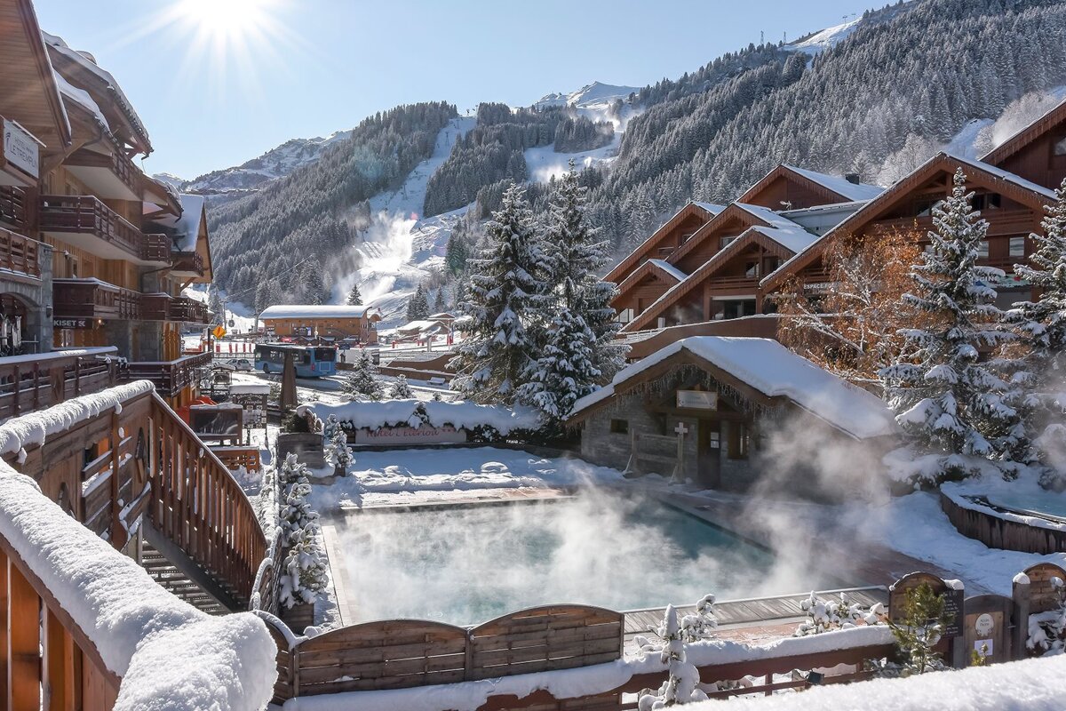 A ski resort with a swimming pool in the middle of it