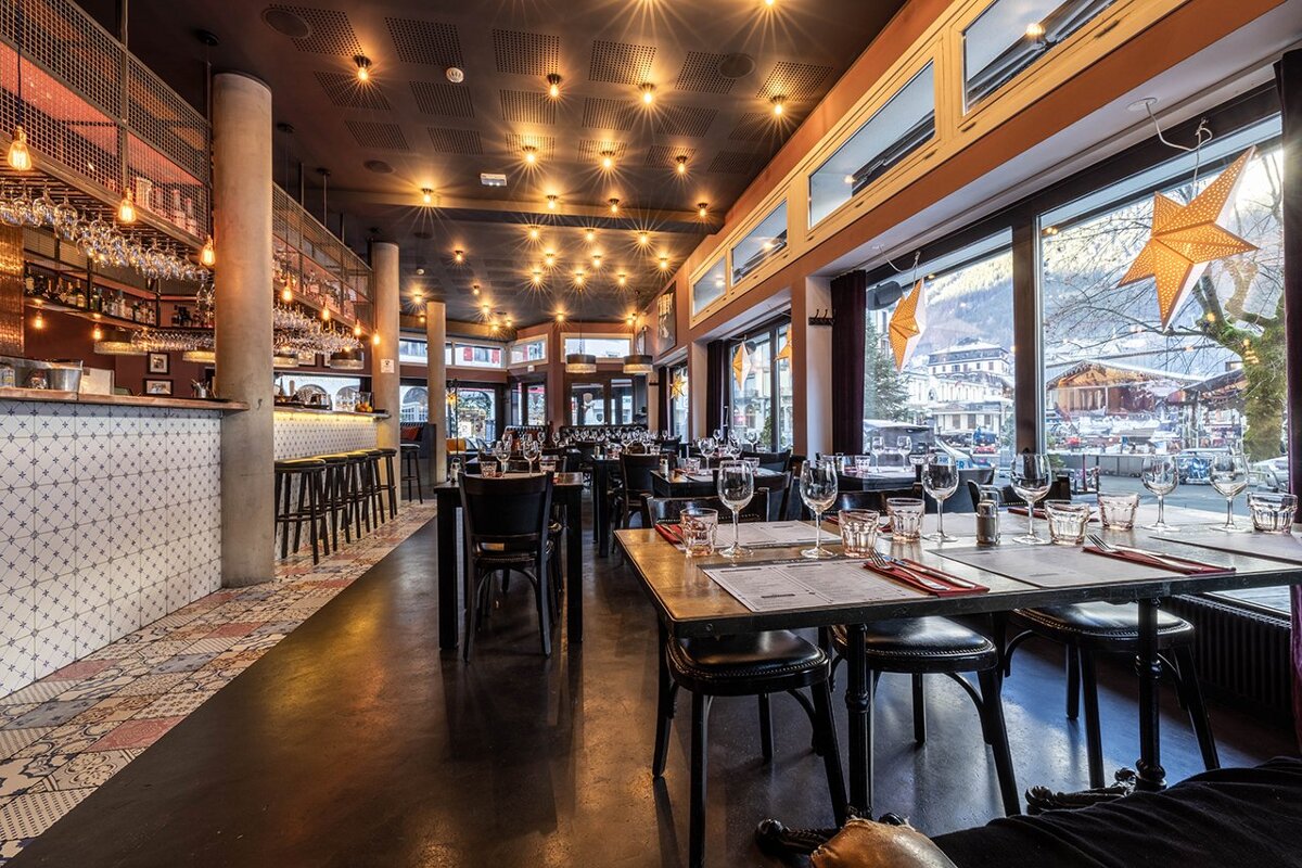 A restaurant with a lot of tables and chairs