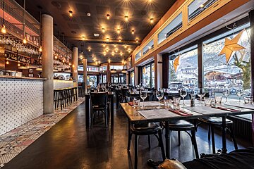 A restaurant with a lot of tables and chairs