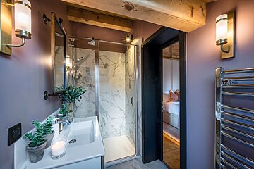 A bathroom with a sink and a walk in shower