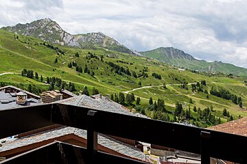 A balcony with a view of a mountain range