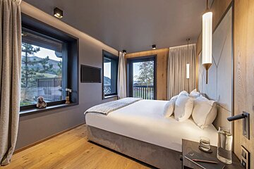 A bedroom with a large bed and a television