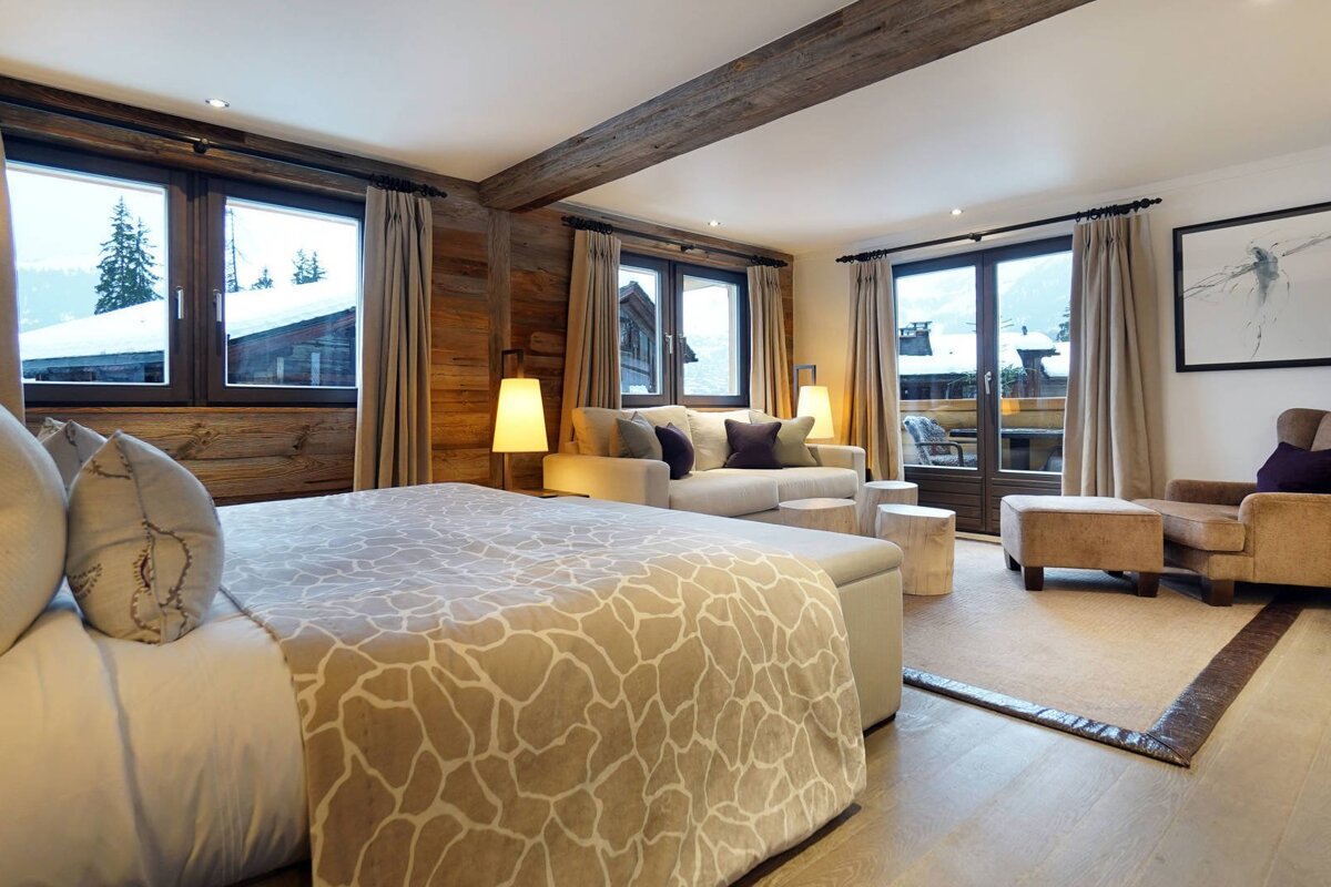 A bedroom with a large bed and a couch