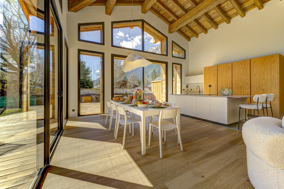 A kitchen and dining area with a table and chairs