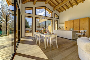 A kitchen and dining area with a table and chairs