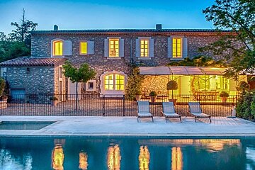 a large stone house and pool