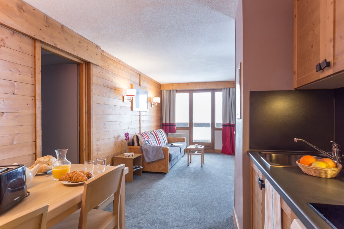 A living room with a couch and a table with a toaster