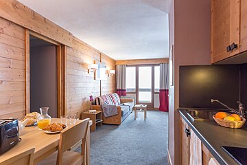 A living room with a couch and a table with a toaster