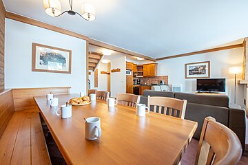 A dining table with a bunch of mugs on it