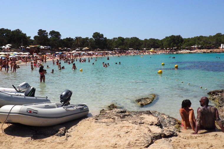 the busy beach & clear waters of cala bassa ibiza