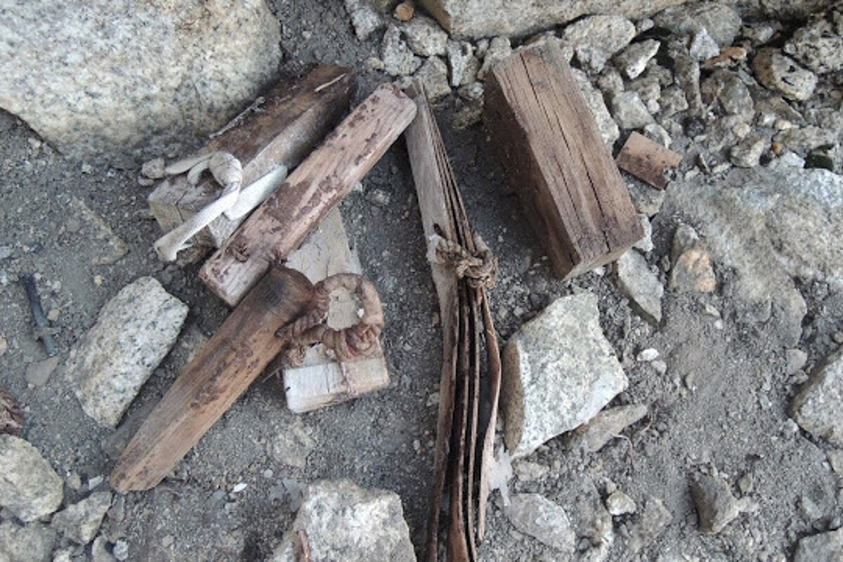 A pile of rocks and wood laying on the ground