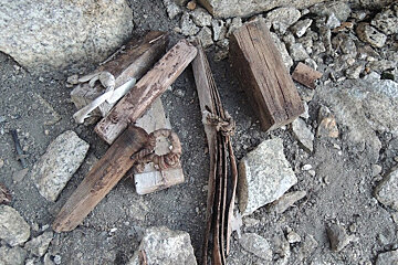 A pile of rocks and wood laying on the ground