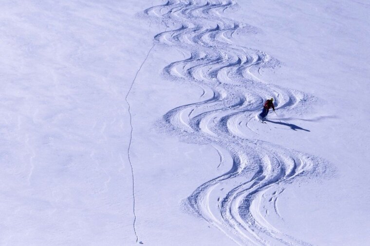 a skier making parallel lines