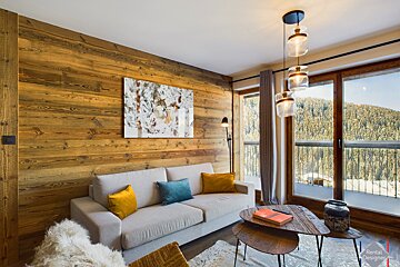 A living room with a couch and a painting on the wall
