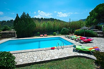 A swimming pool with chairs and umbrellas around it