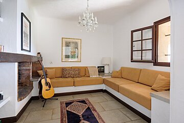 A living room with a couch and a guitar