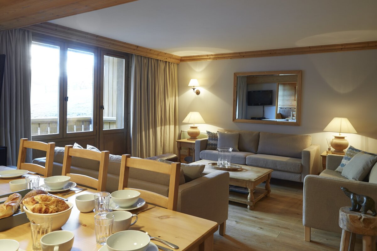 A living room with a dining table and chairs and a couch