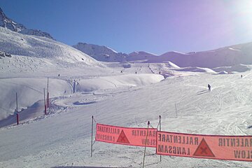 a piste with signs at the bottom
