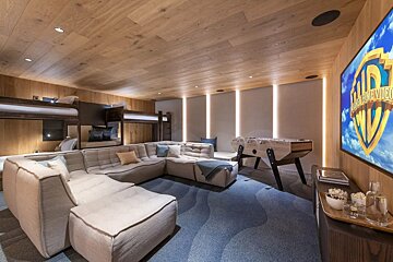 A room with a couch and a tv that says warner bros