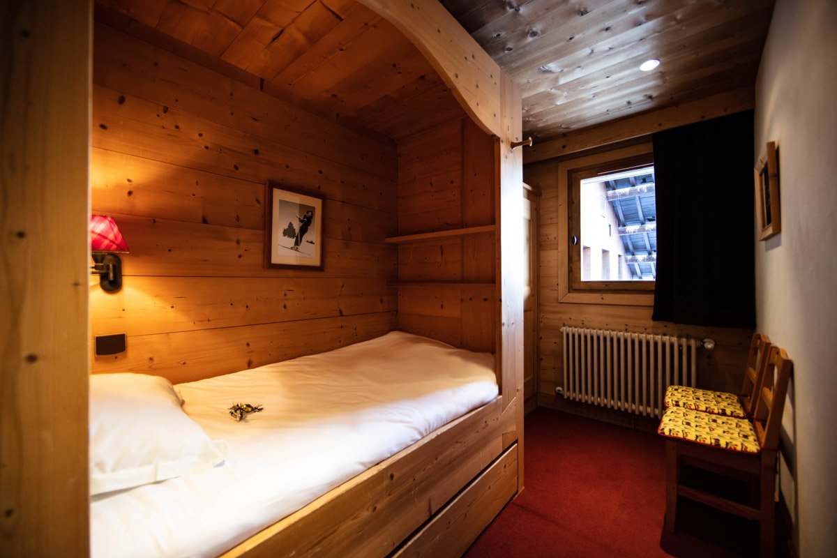 A bedroom with a bed and a picture on the wall