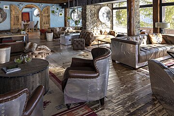 A living room with a lot of furniture and a large window