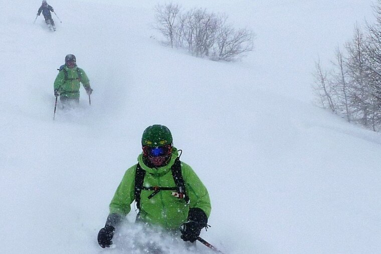 three skiers in a line