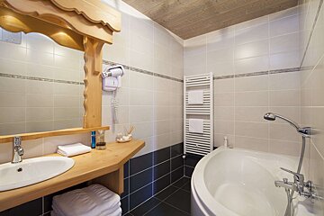 A bathroom with a bathtub and a towel rack