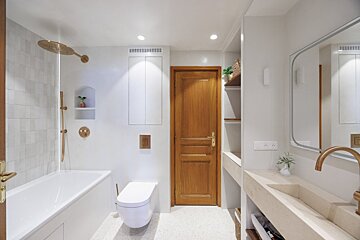 A bathroom with a bathtub toilet and sink