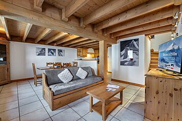 A living room with a couch and a television that says ski a 8500m