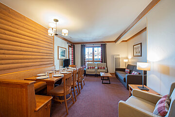 A living room with a table and chairs and a couch