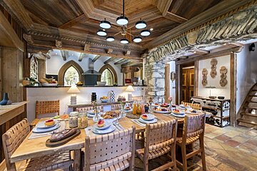 A dining room table with plates of food on it