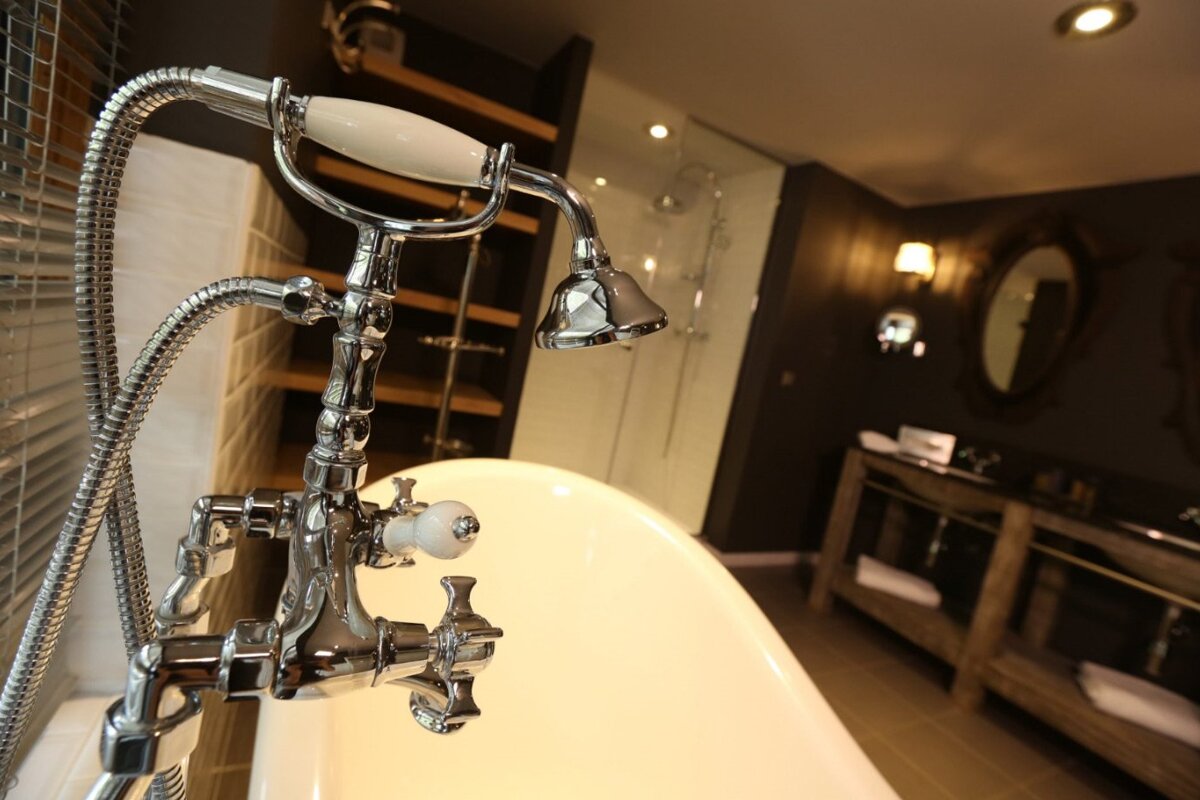 A bathroom with a bathtub and a shower head