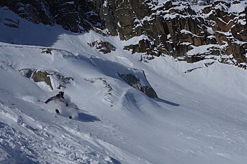 A person is skiing down a snow covered slope