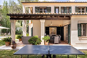 A ping pong table sits in front of a house