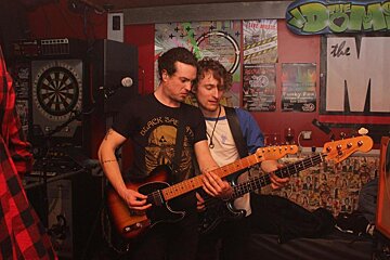 two guitarists in a bar